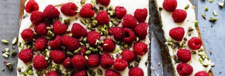 Raspberry, pistachio and lime traybake with cream cheese icing