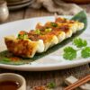 Golden pan-fried shrimp dumplings with crispy bottoms served on a plate